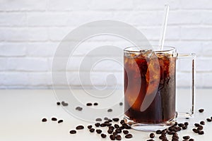 A glass of homemade cold cold brew coffee on white table