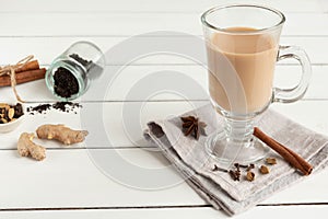 A glass of hot Indian masala tea brewed with aromatic spices and milk