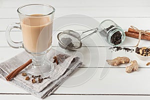 A glass of hot Indian masala tea brewed with aromatic spices and milk