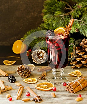 Glass of hot mulled wine for the new year with ingredients for c