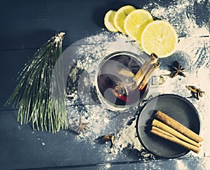 Glass hot Mulled wine with sticks of cinnamon, anise, lemon