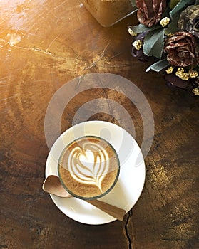 Glass of hot Piccolo coffee on the wooden table