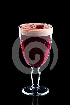 Glass of hot rose burgeon punche isolated on black