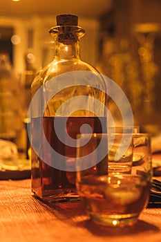 glass with ice and bottle of pacharan whiskey or cognac liqueur