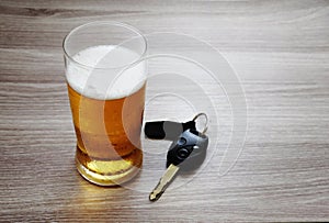 Glass of ice cold beer and car keys./Dont Drink and Drive./Drinking beer and holding