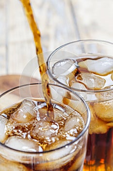 Glass with ice cubes and cola