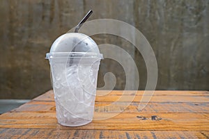 A glass of ice cubes on wooden