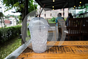 A glass of ice cubes on wooden