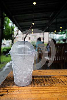 A glass of ice cubes on wooden