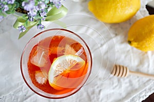 Glass of ice lemon tea with fresh lemon