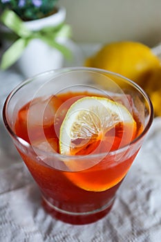 Glass of ice lemon tea with fresh lemon