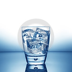 Glass with ice and liquid splash