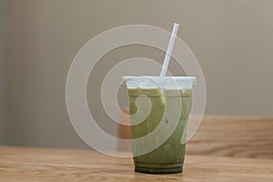 A glass of ice milk green tea in coffee cafe