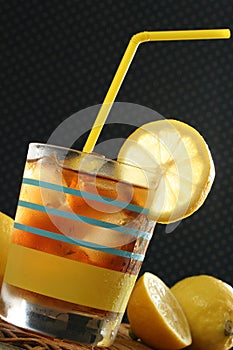 Glass of Ice Tea and Lemons with straw