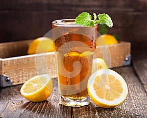 Glass of ice tea with mint and lemon