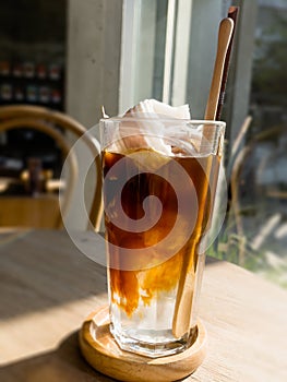 A glass of iced americano with coconut juice