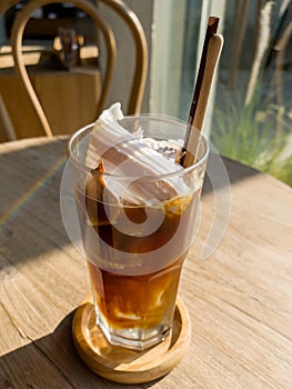 A glass of iced americano with coconut juice