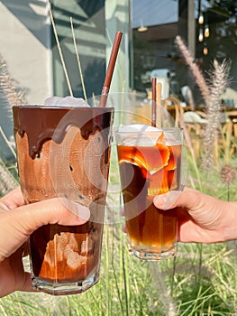 A glass of iced mocha and iced americano with coconut juice