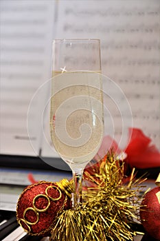 Glass of italian spumante on piano instrument for happy new year with christmas decoration