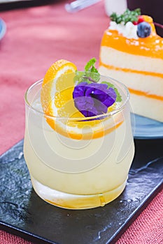 A glass of Japanese iced yuzu fruit tea topped with sliced yuzu orange and mint