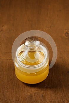 A glass jar with Aquafaba on a brown wooden background photo