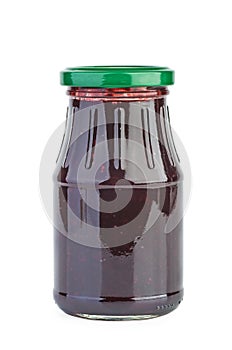 Glass jar with black currants jam isolated on the white background