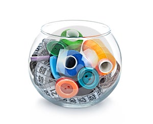 Glass jar, buttons, tape measuring and skeins