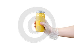 Glass jar of canned applesauce in hand in protective glove. White isolate