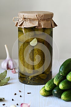 Glass jar with canned cucumbers. Preparations from vegetables for the winter.