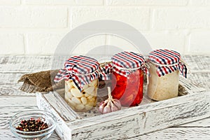 Glass jar with canned garlic  ginger and horseradish. Fermented food on a white background