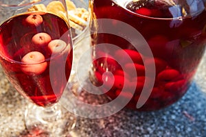 The glass jar of cherry compote, a glass with compote, sweets in a vase, close up