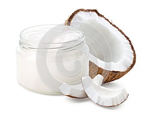 Glass jar of coconut oil and fresh coconut halve and pieces on white background