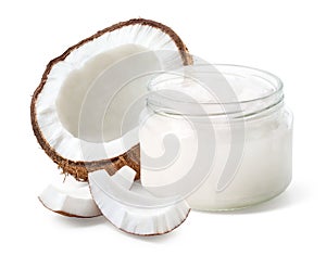 Glass jar of coconut oil and fresh coconut halve and pieces on white background