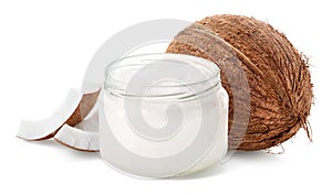 Glass jar of coconut oil and fresh whole coconut and pieces on white background