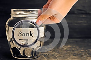 Glass jar with coins and the inscription `Bank`. Deposits, savings and loans. Additional capitalization of banks. Financed public