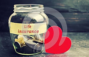 Glass jar with coins and the inscription `Life Insurance`. The concept of medical insurance of life, family, health. Healthcare. R