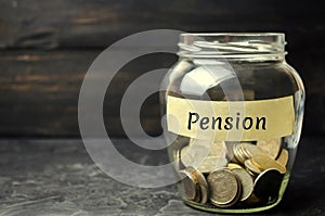 Glass jar with coins and the inscription `Pension`. Saving money, annuity insurance, retirement. Future investment. Accumulation o
