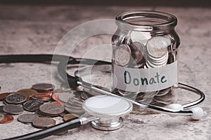 Glass jar with coins. Medical donation concept