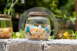 A glass jar with colored stones