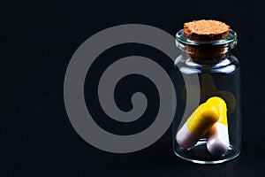 glass jar with colorful pills
