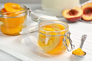 Glass jar with conserved peach halves