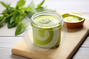 glass jar containing homemade baby puree on a table