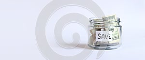 Glass jar with dollars on a white background. Piggy bank with banknotes