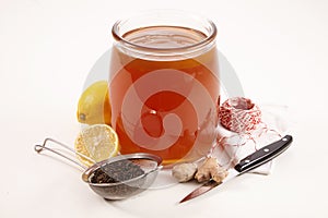 Glass jar of fermented sweetened Kombucha tea photo