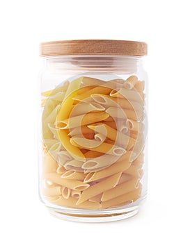 Glass jar filled with penne pasta isolated