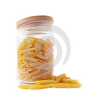 Glass jar filled with penne pasta isolated