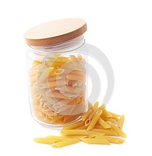 Glass jar filled with penne pasta isolated