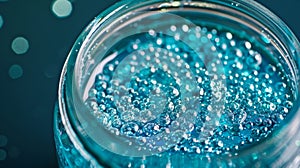 A glass jar filled with water and filled with tiny plastic beads is shown in the sixth image. The beads coated in a