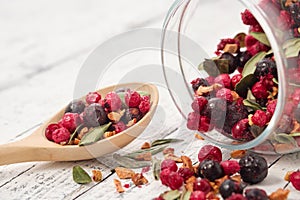 Glass jar of fruit tea with apples, orange, red and black currant berries