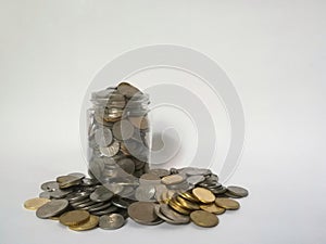 A glass jar full of coins